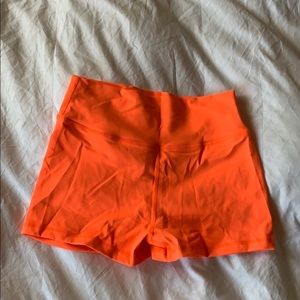 In muscle nation orange scrunch butt shorts